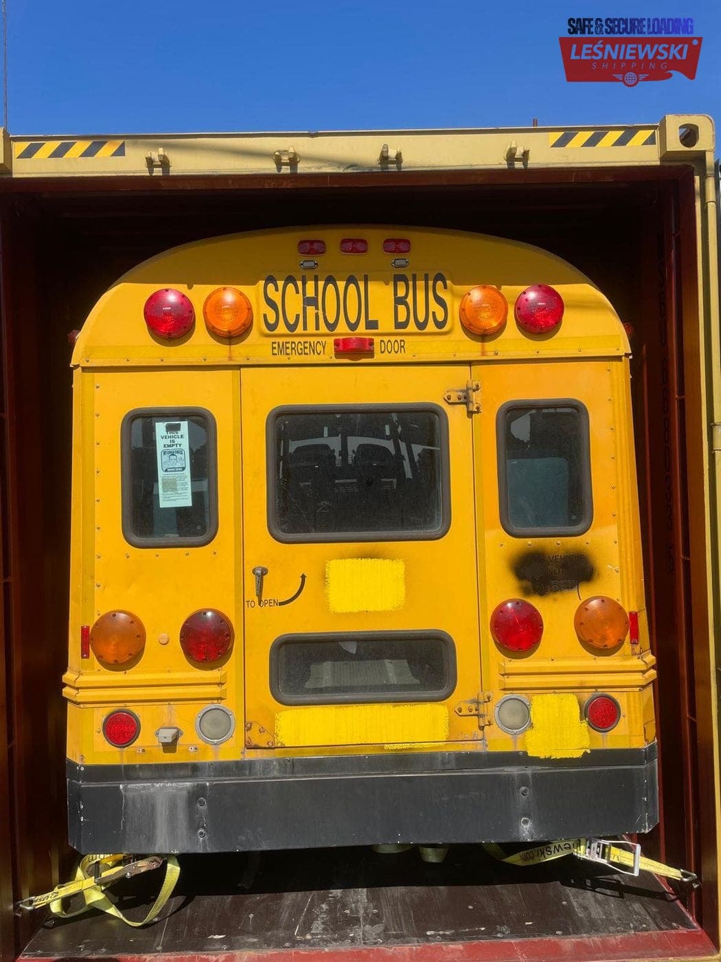 Yellow American school bus in a container — vehicle transport from the USA