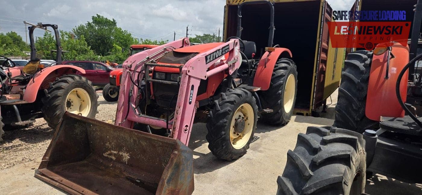 Red Zetor farm tractor with a loader — agricultural machinery transport from the USA