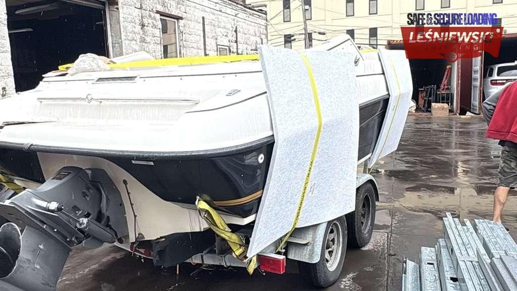 White motorboat on a trailer before loading — boat transport from the USA