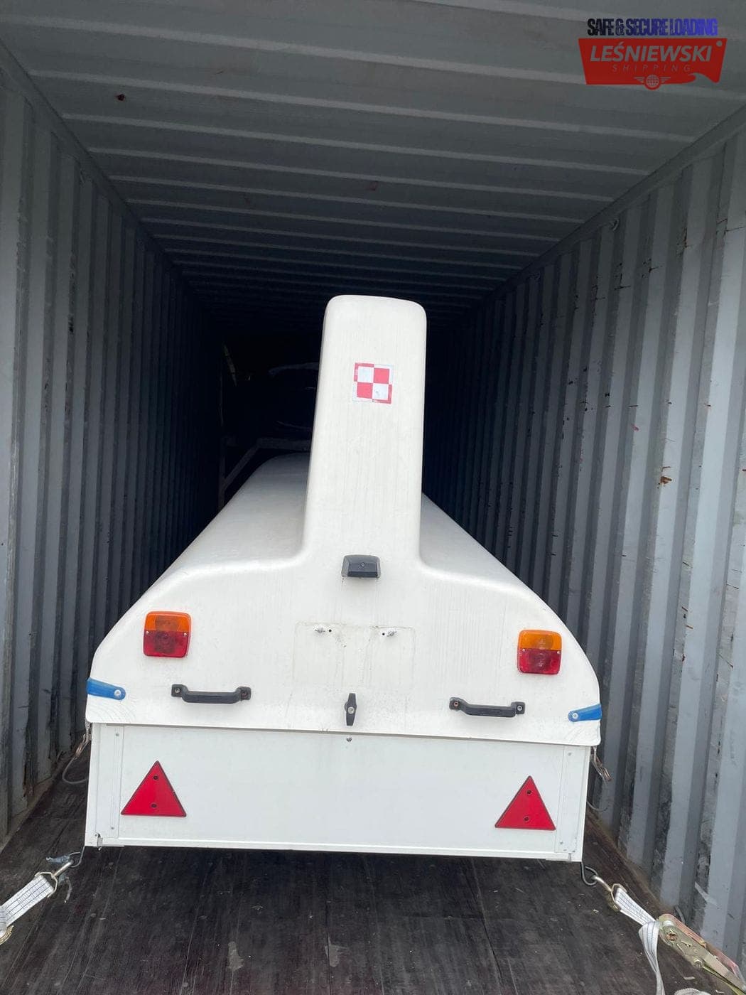 Boat hull on a trailer loaded in a container — boat transport from the USA