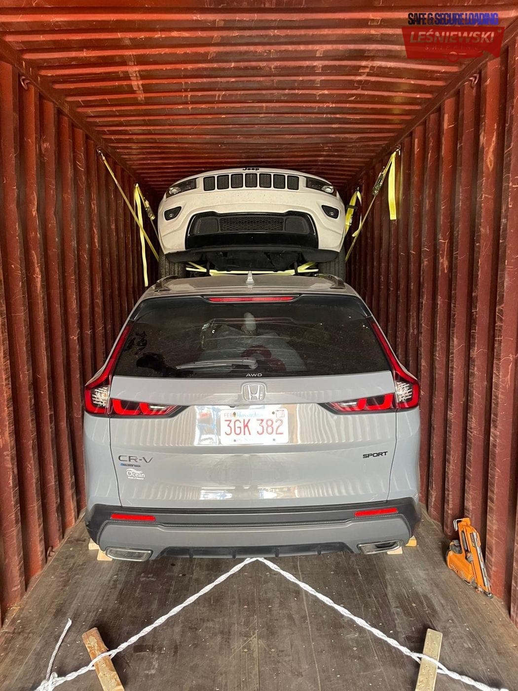 Honda CR-V and Jeep stacked in a container — car import from the USA to Poland