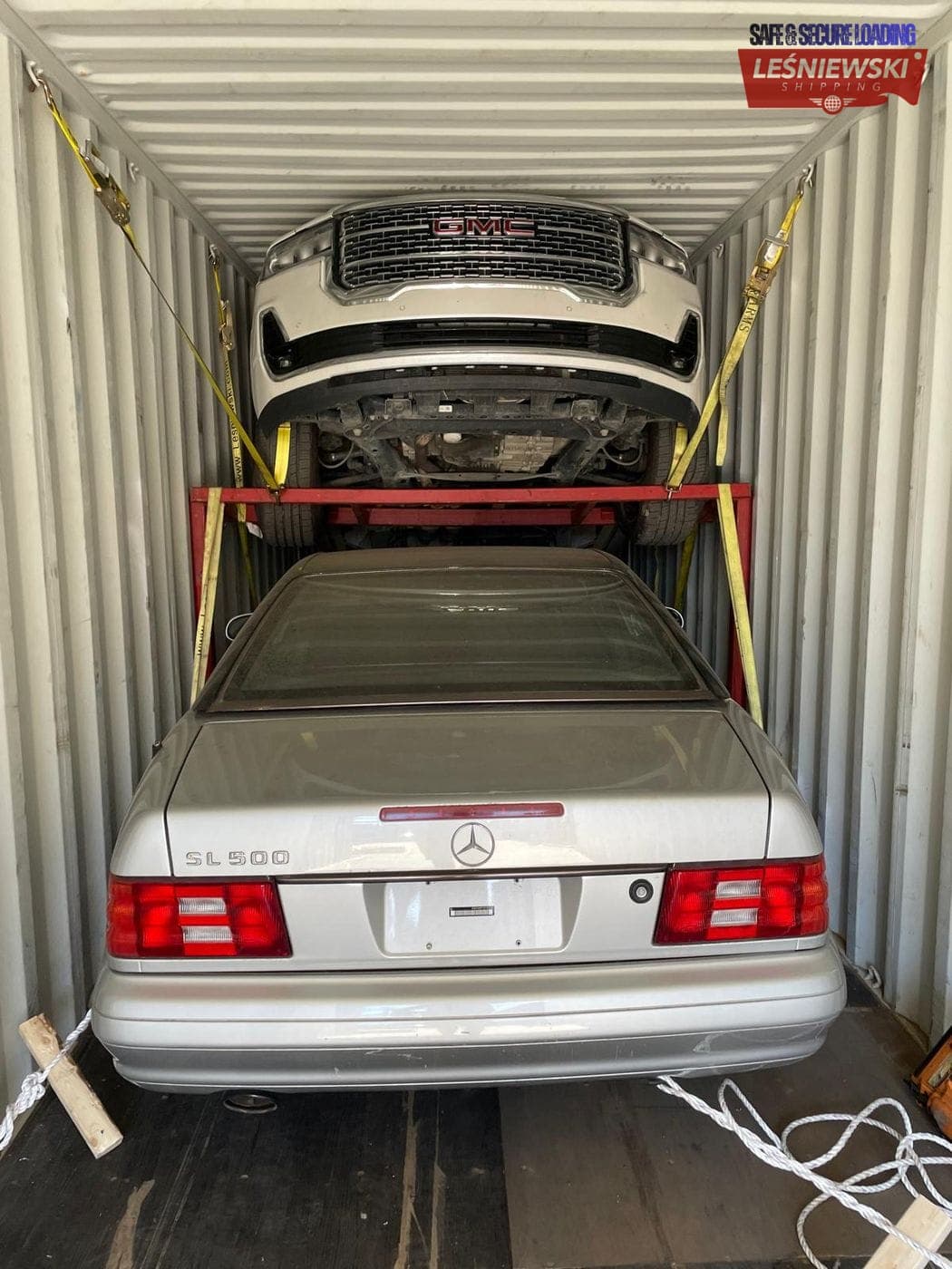 Two cars stacked in a container — Mercedes SL and pickup, import from the USA