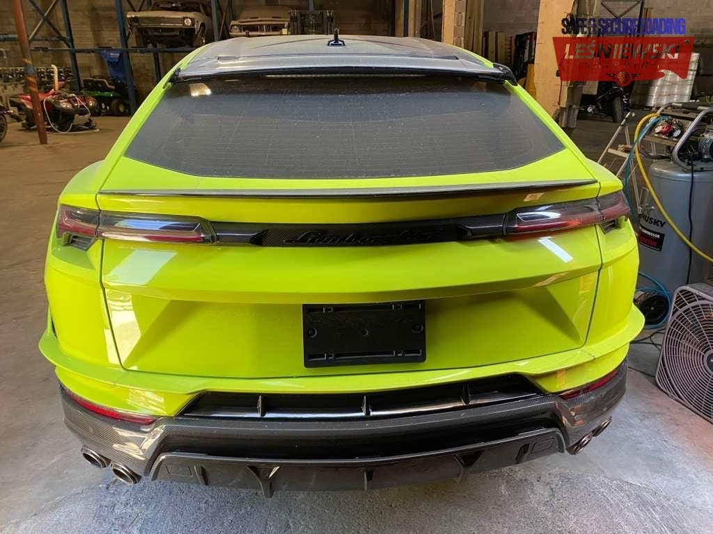 Lime green Lamborghini Urus in a workshop before transport to Poland