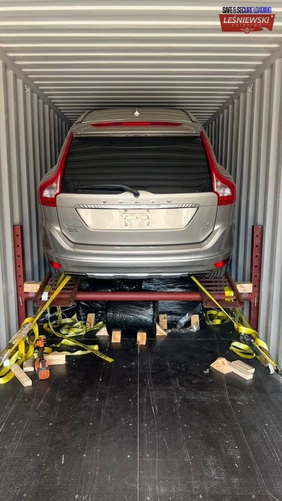 Silver Volvo XC60 on a rack in a container — car shipping USA to Poland