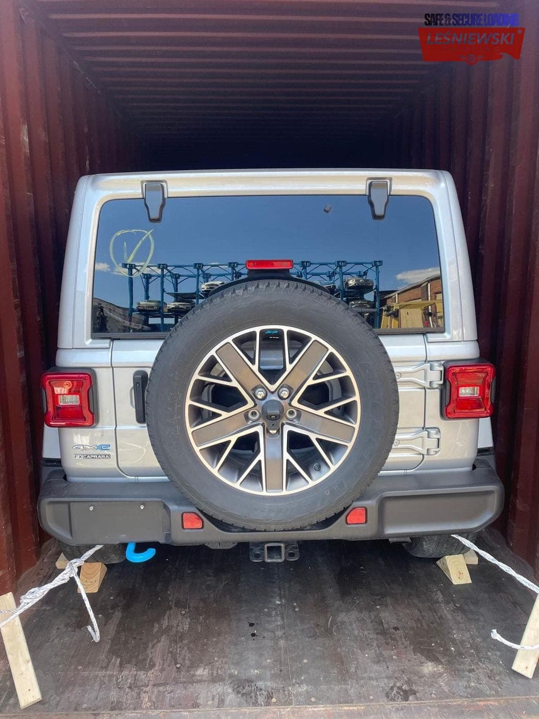 Silver Jeep Wrangler secured in a container — car import from the USA
